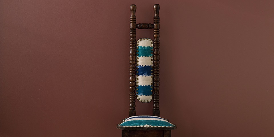 decorative fabric on chair with dark red background