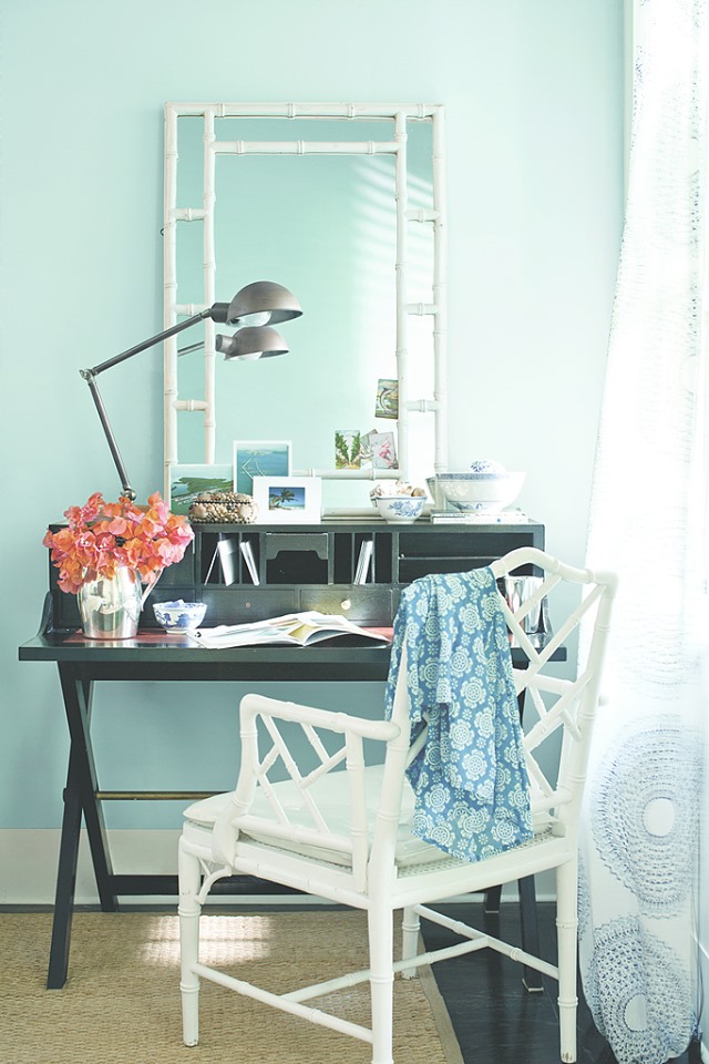 light green office with lamp on desk, mirror and chair in white